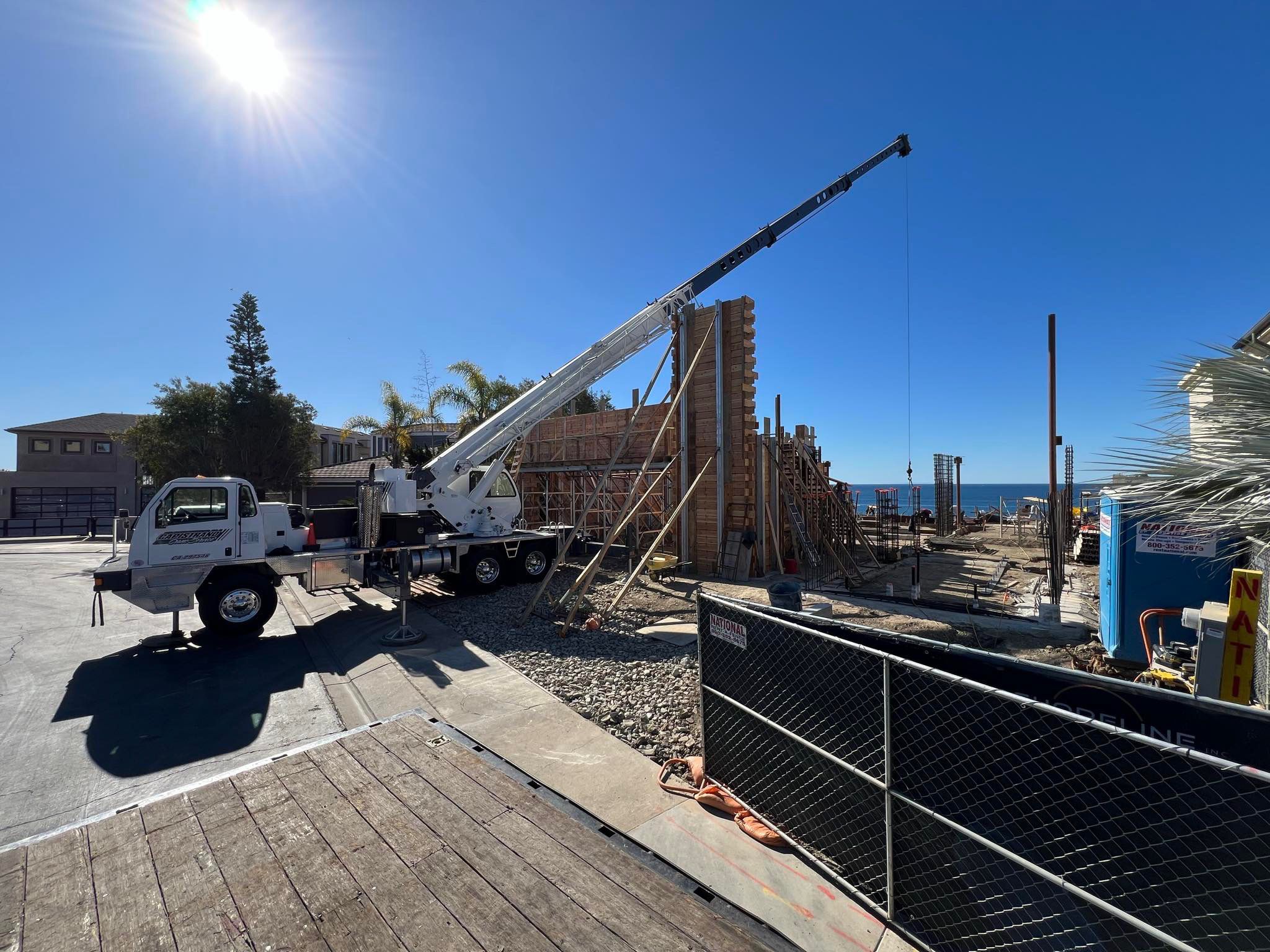 Crane and construction crew on residential job site