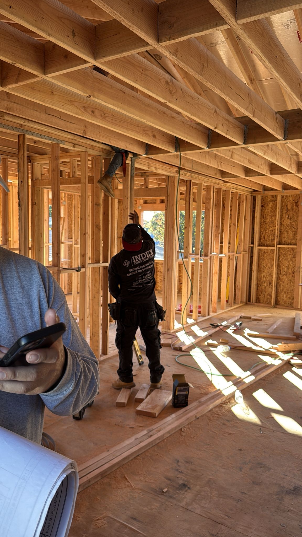 Index Construction team collaborating with blueprints on site