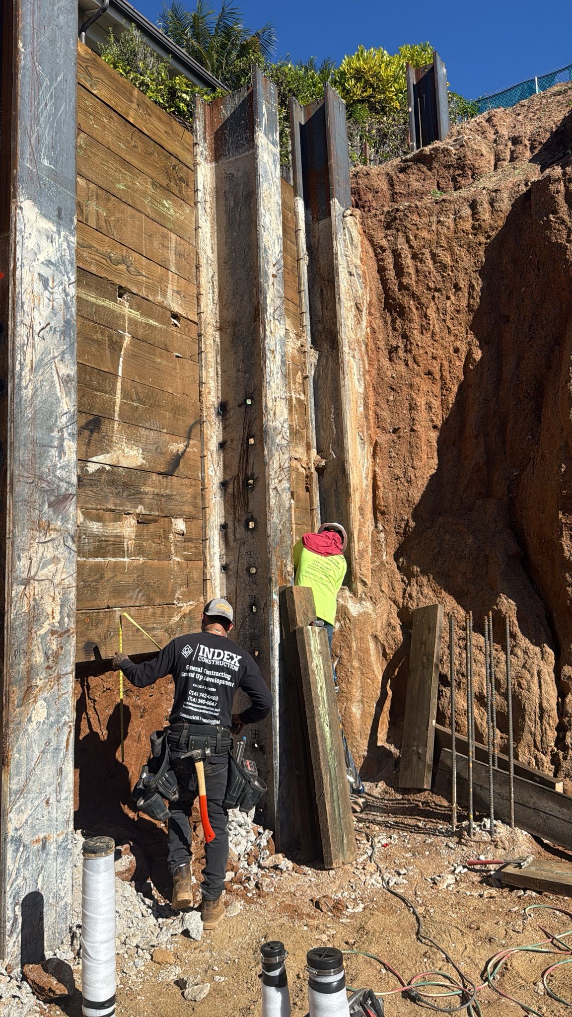 Index Construction worker at shoring wall on steep hillside